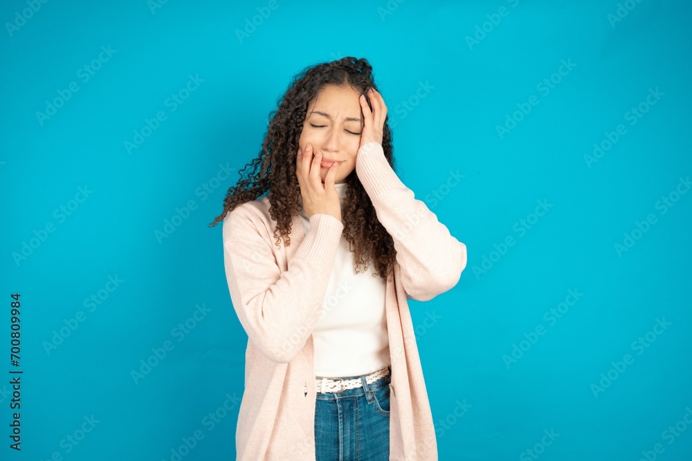 Doleful desperate crying beautiful teen girl, looks stressfully, frowns face, feels lonely and anxious Doleful desperate crying beautiful teen girl, looks stressfully, frowns face, feels lonely and anxious