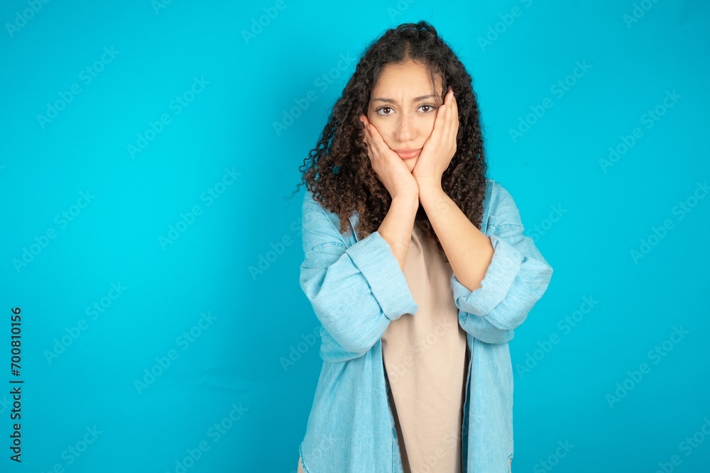 beautiful teen girl wearing denim jacket Tired hands covering face, depression and sadness, upset and irritated for problem