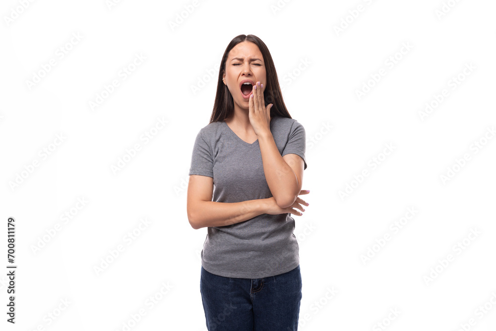young tired brunette woman dressed in a gray basic t-shirt with print mockup. uniform concept young tired brunette woman dressed in a gray basic t-shirt with print mockup. uniform concept