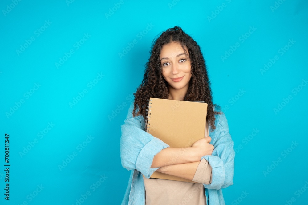 beautiful teen girl wearing denim jacket happy face smiling with crossed arms looking at the camera. Positive person. beautiful teen girl wearing denim jacket happy face smiling with crossed arms looking at the camera. Positive person.