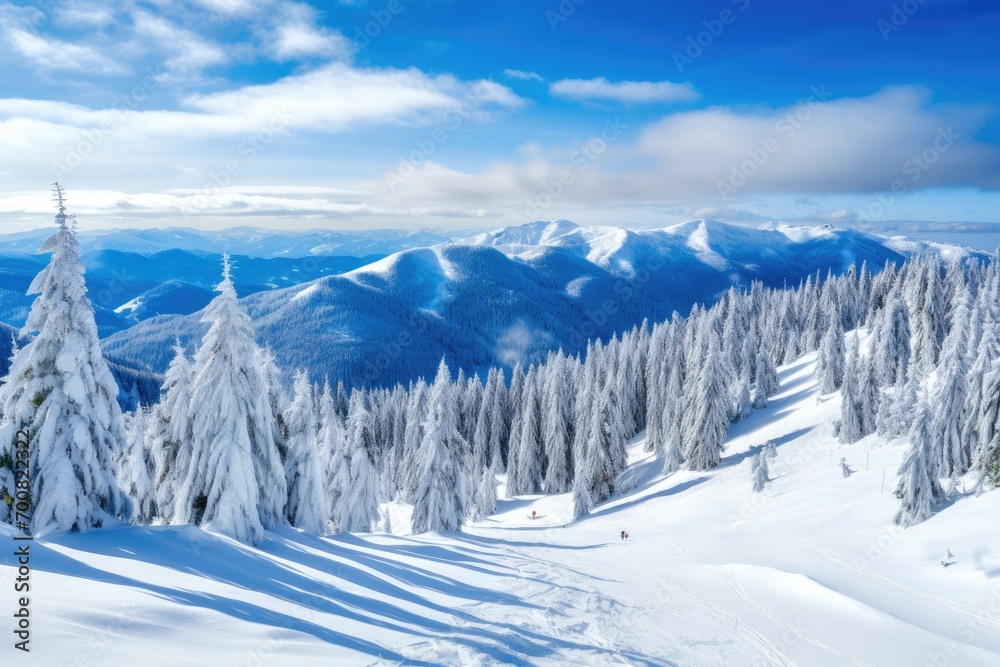 Panorama of mountains with snowy off-piste slope and blue sunlit sky at winter.