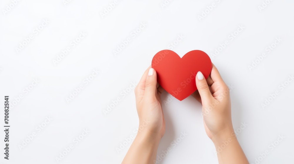 Fototapeta premium Love in the Palm: A Tender Gesture of Affection Captured in a Delicate Paper Heart on a Serene White Background