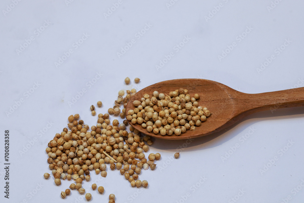 coriander in a wooden spoon isolated on white background coriander in a wooden spoon isolated on white background