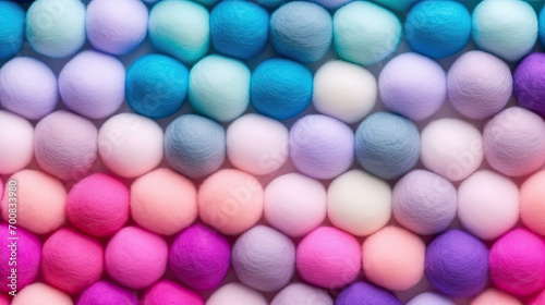 Background of colorful fuzzy pom poms of felt, pastel colors