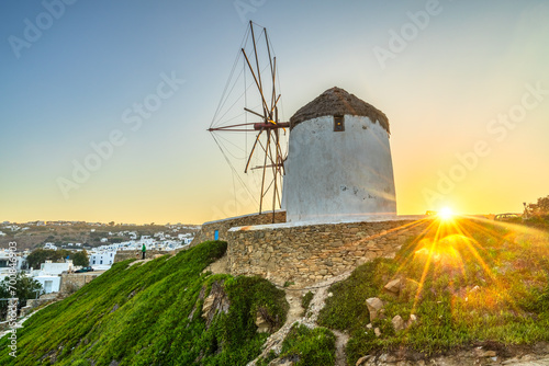 Famous white windmill near the coast of Mykonos island at sunrise