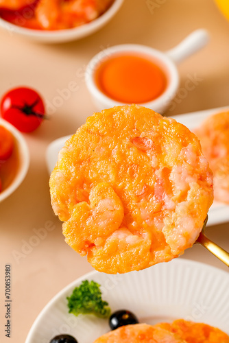 Shrimp steaks, snack made with shrimps and vegetables, children's food fried, golden and pink meat texture, closeup on tabletop indoors