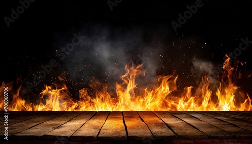 A wooden table in front with the fire and smoke.