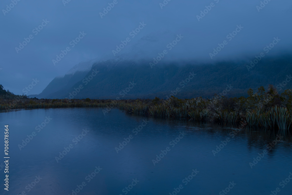 Photograph of a mountain range behind Mirror Lakes in Fiordland National Park on the South Island of New Zealand