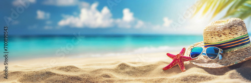 Hat, sunglasses and starfish on sandy beach. Summer tropical vacation concept