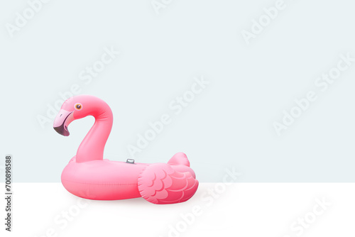 Pink pool plastic inflatable flamingo with light blue background photo