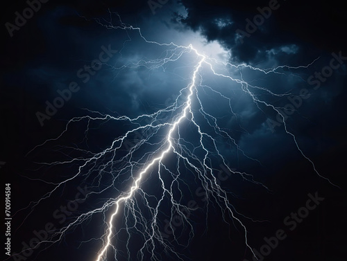 A branched lightning bolt in dark night clouds. natural lightning isolated on black background. Thunderstorm in clouds. Thunder, lightnings and rain during summer storm. Lightning strike.