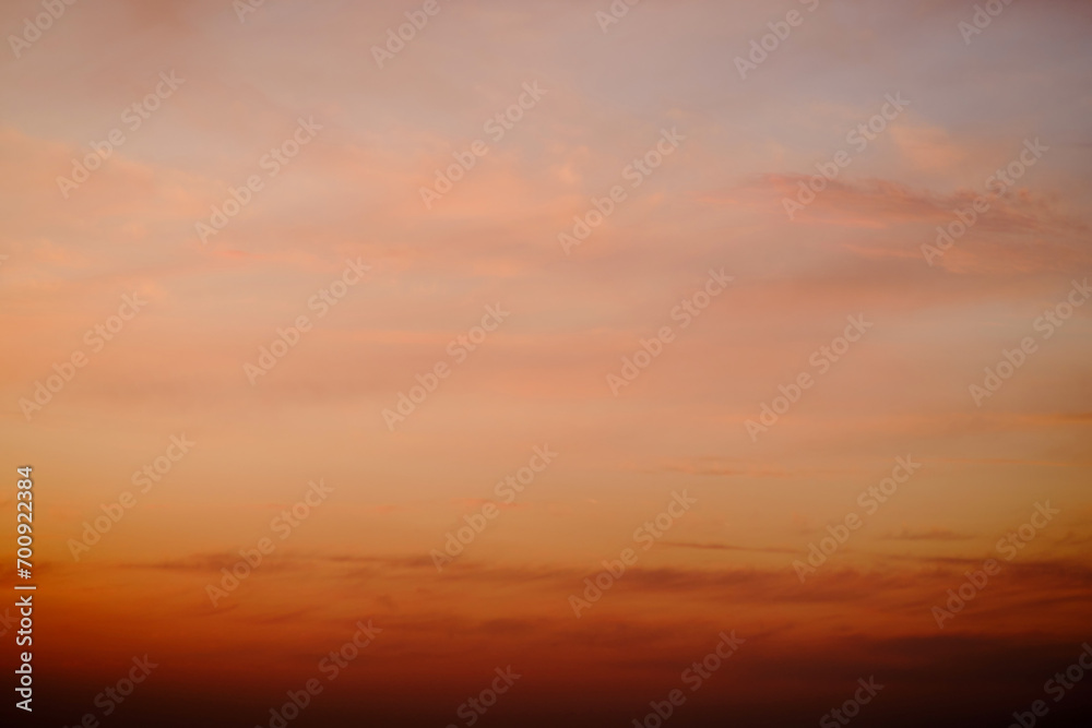 Fototapeta premium Evening clouds in the sunset sky in the light of the rays of the setting sun