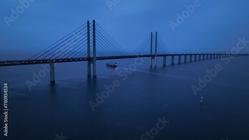 Panoramic Aerial view of Oresund Bridge who is a combined motorway and railway, sea bridge between Denmark and Sweden (Copenhagen and Malmo) and ship - seascape of Baltic Sea, Europe from above photo