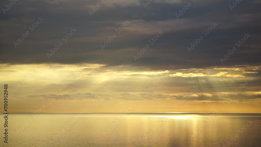 Timelapse fluffy Cumulus clouds moving in bright golden sunset sky over sea. Abstract aerial nature summer ocean sunset, sea and sky view. Vacation, travel, holiday concept. Weather and Climate Change Timelapse fluffy Cumulus clouds moving in bright golden sunset sky over sea. Abstract aerial nature summer ocean sunset, sea and sky view. Vacation, travel, holiday concept. Weather and Climate Change