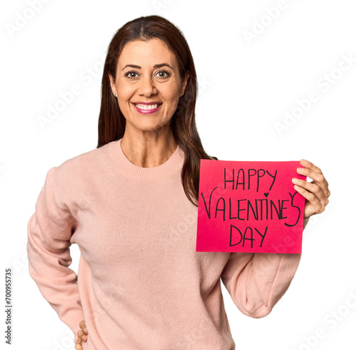 Middle-aged Caucasian woman holding Valentine's sign in studio