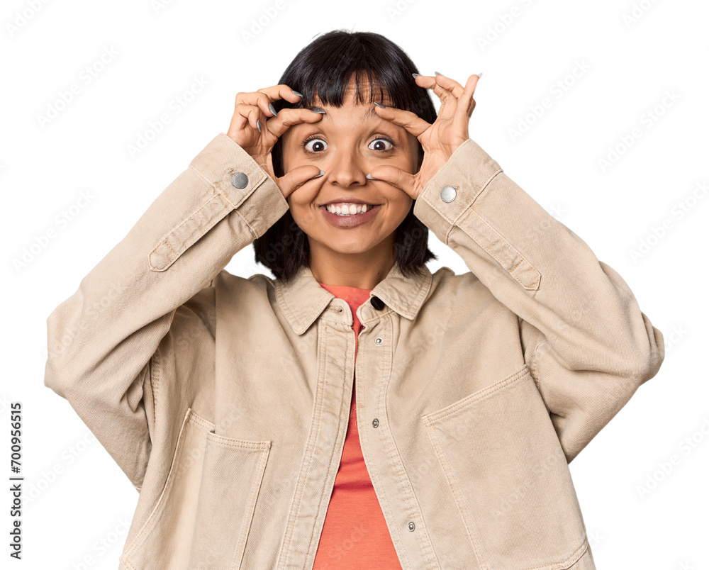 Young Hispanic woman with short black hair in studio keeping eyes opened to find a success opportunity. Young Hispanic woman with short black hair in studio keeping eyes opened to find a success opportunity.