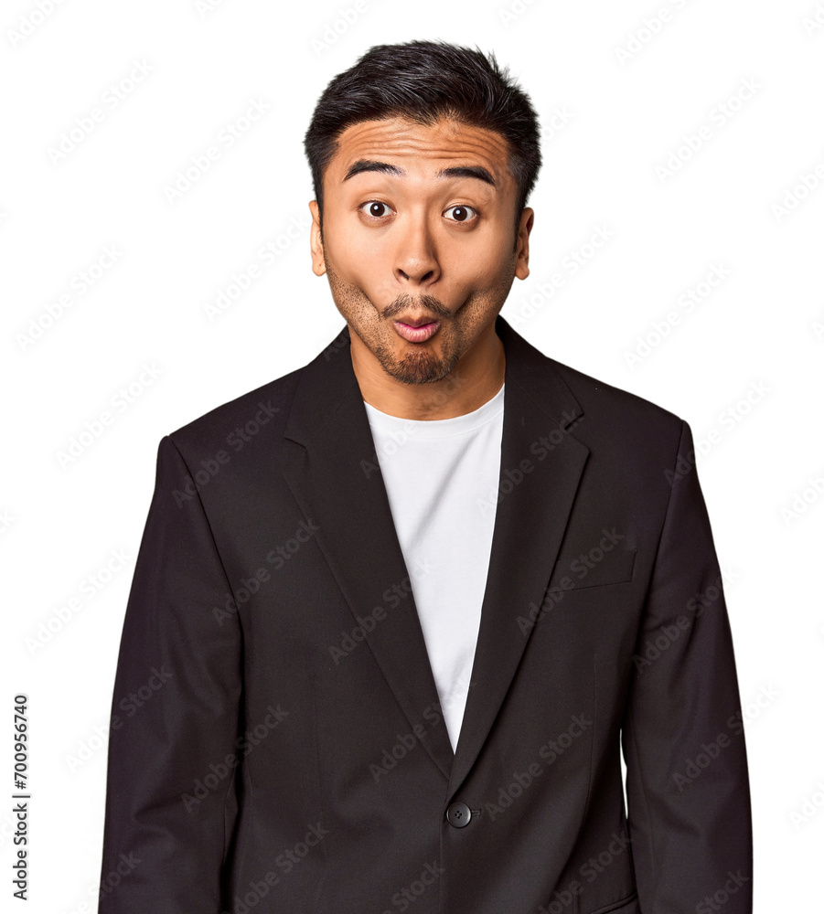 Young Chinese man in business suit in studio shrugs shoulders and open eyes confused. Young Chinese man in business suit in studio shrugs shoulders and open eyes confused.