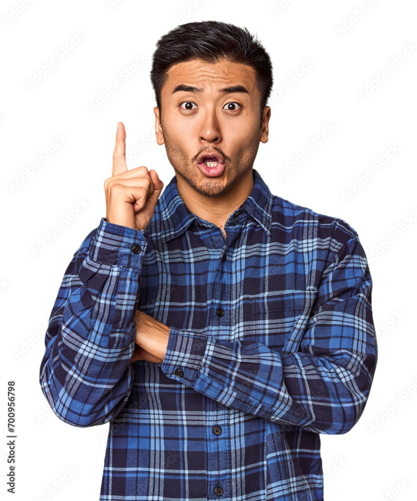 Young Chinese man in studio background having some great idea, concept of creativity. Young Chinese man in studio background having some great idea, concept of creativity.
