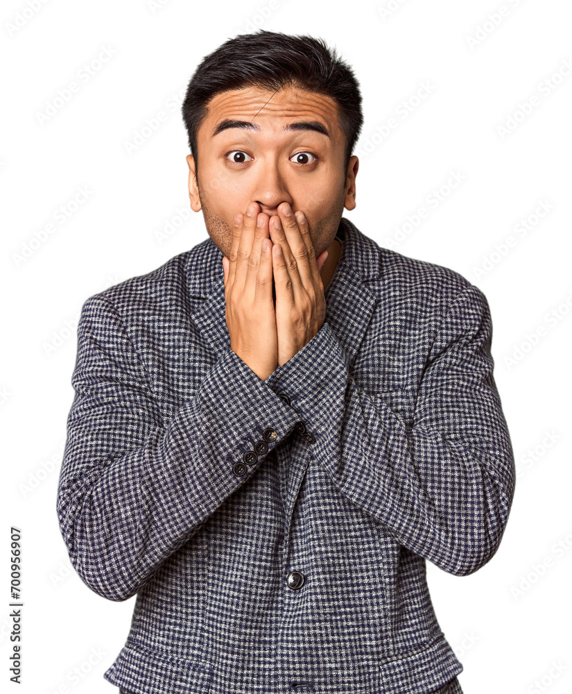 Young Chinese man in studio background shocked, covering mouth with hands, anxious to discover something new. Young Chinese man in studio background shocked, covering mouth with hands, anxious to discover something new.
