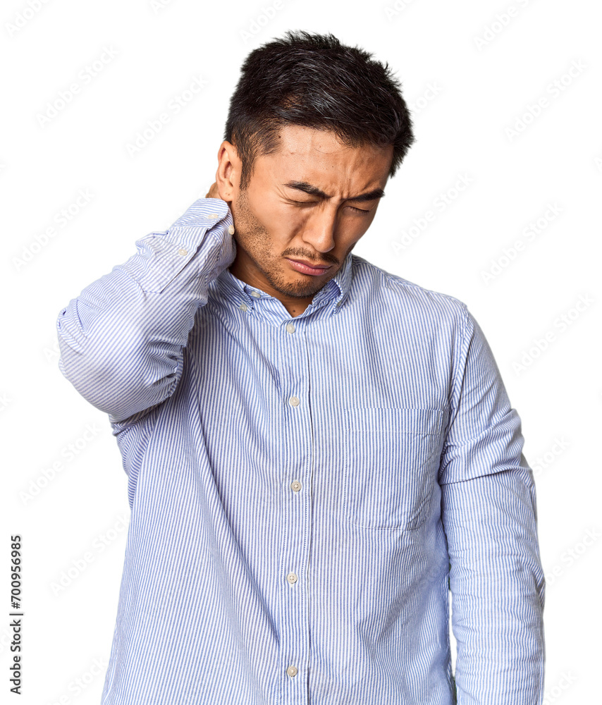 Young Chinese man in studio background suffering neck pain due to sedentary lifestyle. Young Chinese man in studio background suffering neck pain due to sedentary lifestyle.