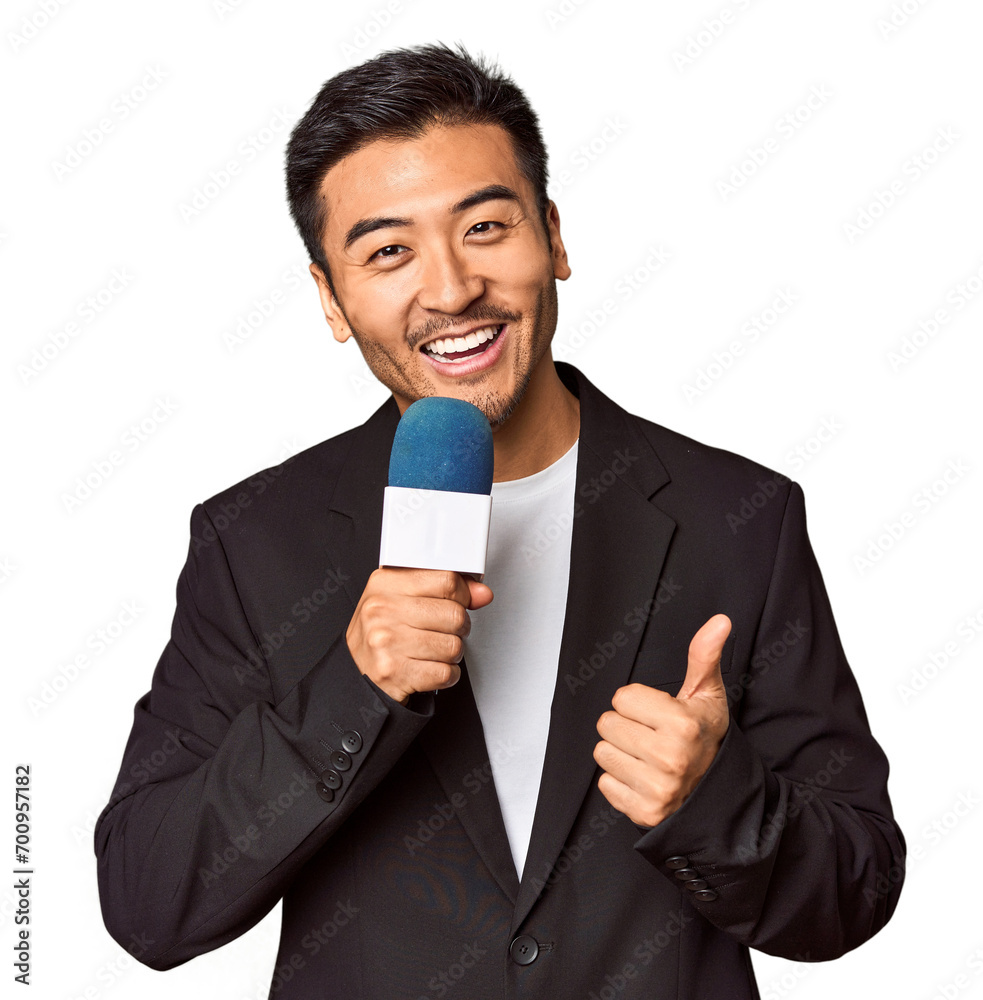 Young Chinese TV presenter reporting news with microphone in studio Young Chinese TV presenter reporting news with microphone in studio