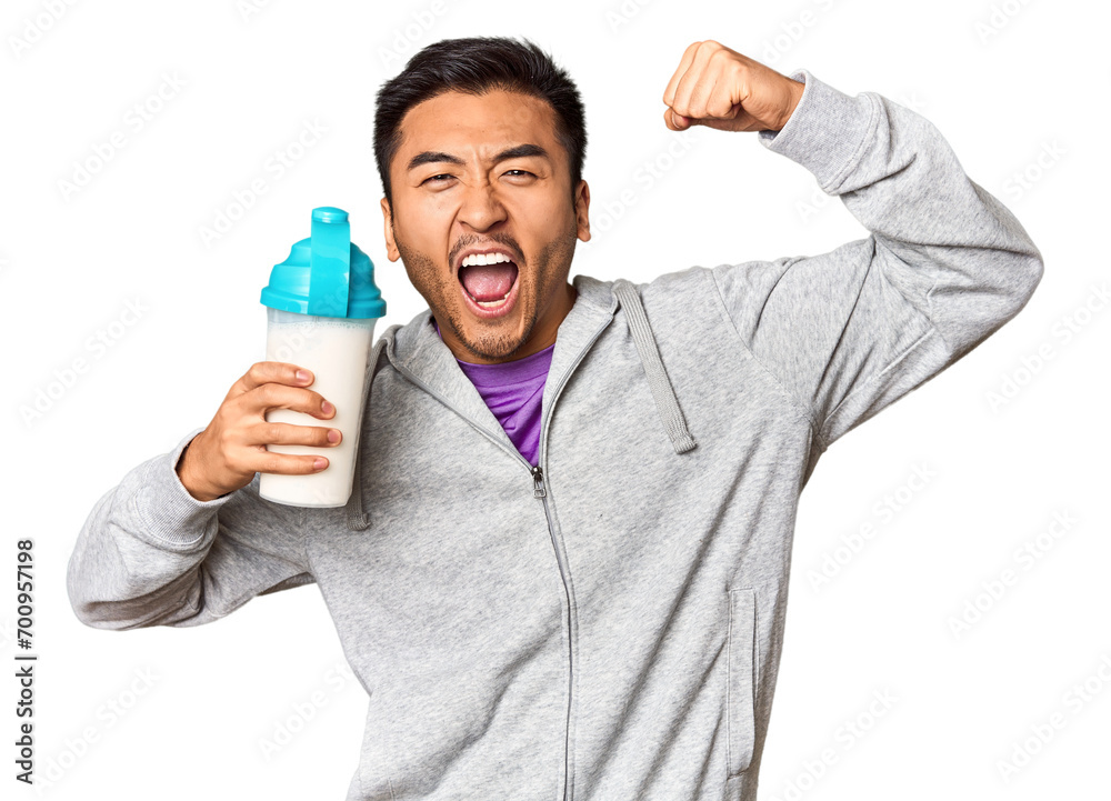 Fit Chinese male with protein shake and bottle in studio setup Fit Chinese male with protein shake and bottle in studio setup