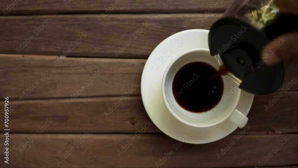 Top view of fresh black coffee poured into empty cup on wooden background, dark coffee drink, health benefits of espresso, americano, breakfast concept
Top view of fresh black coffee poured into empty cup on wooden background, dark coffee drink, health benefits of espresso, americano, breakfast concept