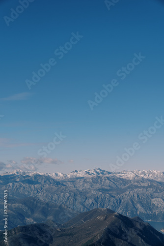 Mountain range above the Bay of Kotor against the blue sky in winter. Montenegro