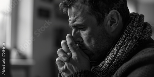A man in a scarf is shown in prayer. This image can be used to depict spirituality and devotion