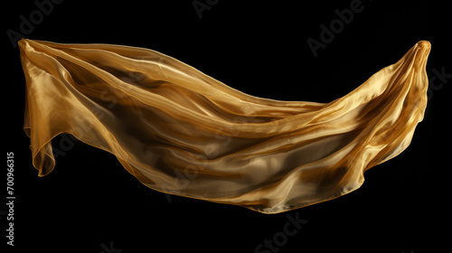 Gold cloth that is floating and hiding something unknown underneath. Fabric isolated on black background. 