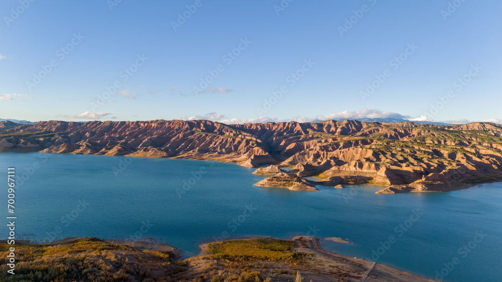 Aerial drone photo of the lake surrounded by mountains named Negratin in Spain