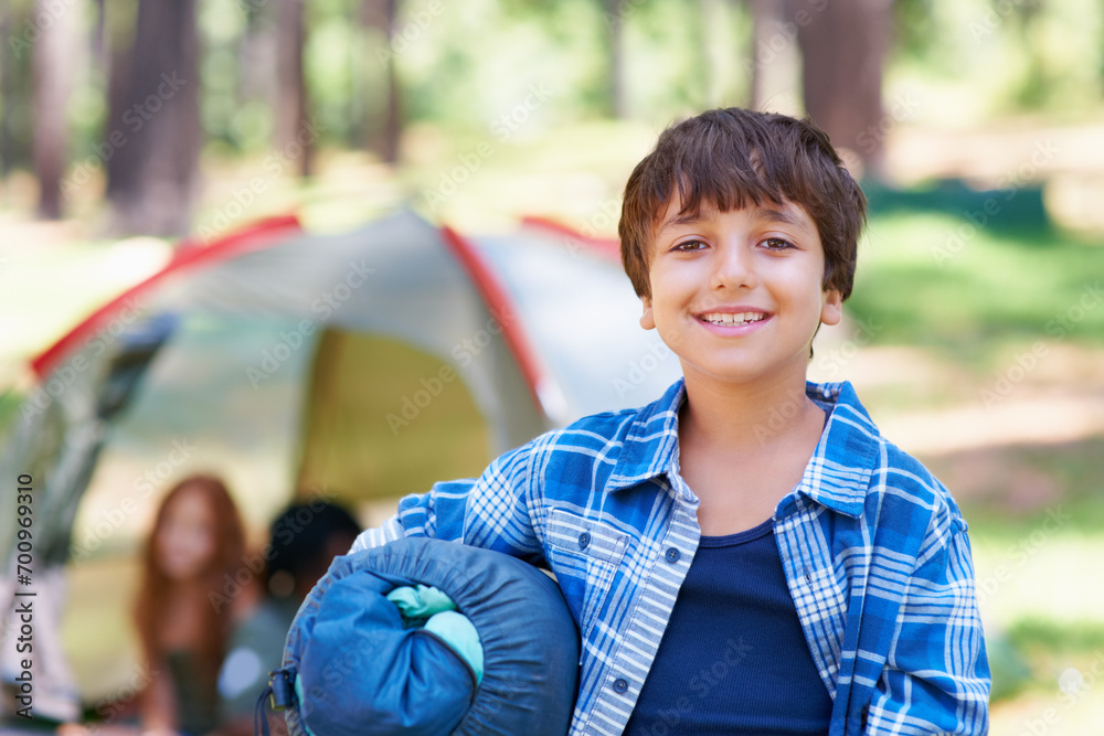 Sleeping bag, camping or portrait of happy kid in woods for adventure or holiday vacation in park. Relax, start or boy with smile in nature, garden or forest ready for fun hiking, travel or wellness Sleeping bag, camping or portrait of happy kid in woods for adventure or holiday vacation in park. Relax, start or boy with smile in nature, garden or forest ready for fun hiking, travel or wellness