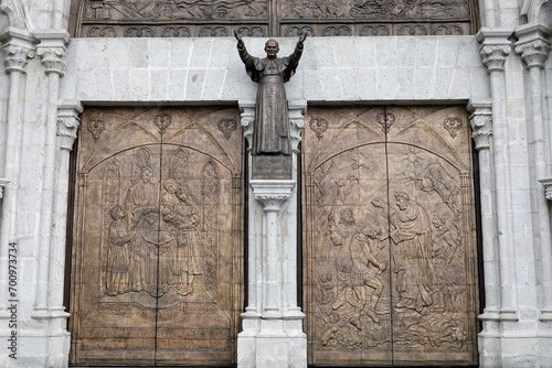 Basilica of the National Vow (Spanish: BasÃ­lica del Voto Nacional), Roman Catholic church located in the historic center of Quito, Ecuador. Doors with reliefs and statue of pope John Paul II photo