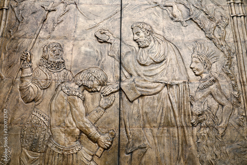 Basilica of the National Vow,  Roman Catholic church located in the historic center of Quito, Ecuador. Detail of door relief depicting a monk baptizing an American native