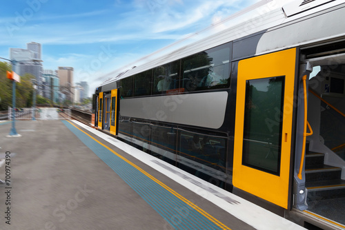 Commuter Train fast moving through a Station in Sydney NSW Australia locomotive electric light rail