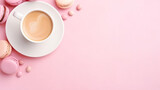 Coffee, macaron cake, blank notebook on pink table top view. Women's desktop. Cozy breakfast.