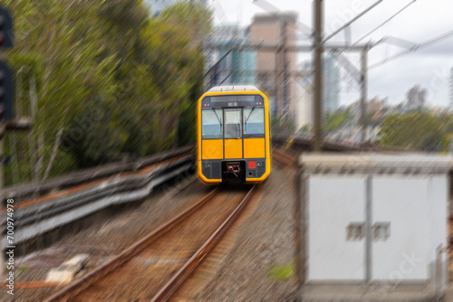 Commuter Train fast moving through a Station in Sydney NSW Australia locomotive electric light rail