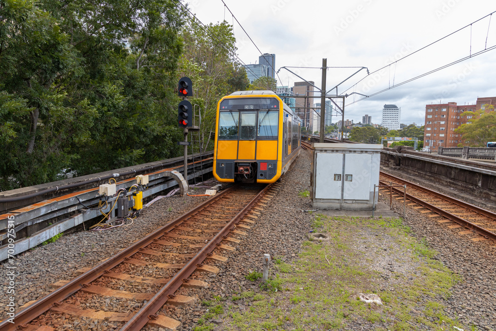 Naklejka premium Commuter Train fast moving through a Station in Sydney NSW Australia locomotive electric light rail