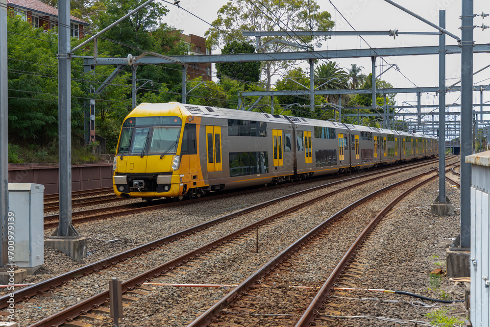 Commuter Train fast moving through a Station in Sydney NSW Australia locomotive electric light rail