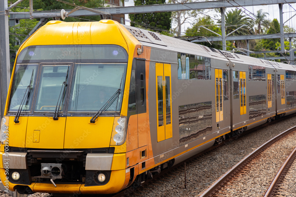 Commuter Train fast moving through a Station in Sydney NSW Australia locomotive electric light rail