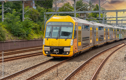 Commuter Train fast moving through a Station in Sydney NSW Australia locomotive electric light rail