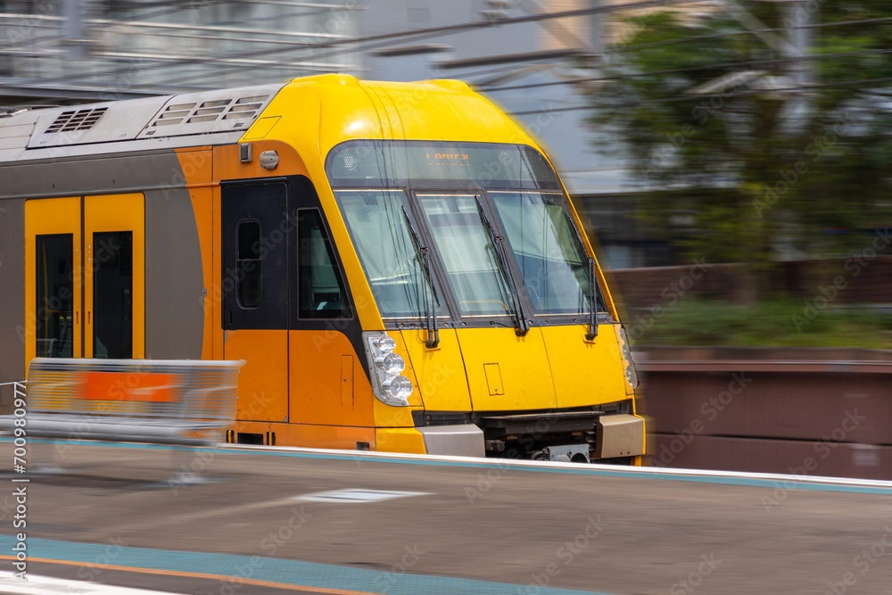 Obraz premium Commuter Train fast moving through a Station in Sydney NSW Australia locomotive electric light rail
