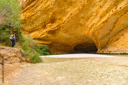 Photos Woman with backpack in the cave on the Vero River walkway path in Alquezar
