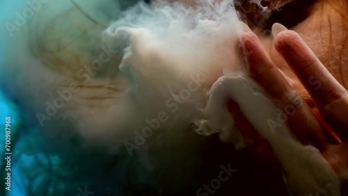 underwater, closeup view of woman face in depth, touching glass and exhaling milk photo