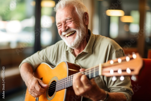 An smilling older person play a guitar