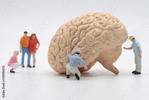 miniature characters around a human brain