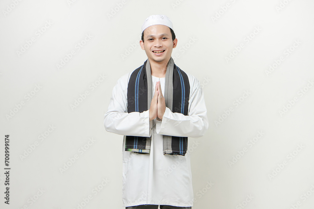 happy asian muslim man greeting gesture. People religious Islam lifestyle concept. celebration Ramadan and ied Mubarak. on isolated background. happy asian muslim man greeting gesture. People religious Islam lifestyle concept. celebration Ramadan and ied Mubarak. on isolated background.
