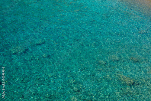 Fototapeta Naklejka Na Ścianę i Meble -  Amazing transparent and clear see-through turquoise waters at the beautiful beach of Tripiti in Ios cyclades Greece