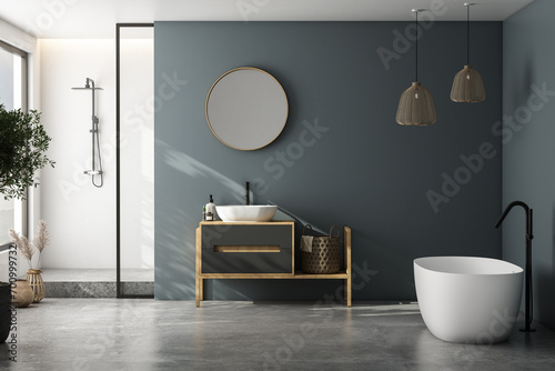 Modern minimalist bathroom interior, modern bathroom cabinet, white sink, wooden vanity, interior plants, bathroom accessories, bathtub and shower, white and blue walls, concrete floor. photo