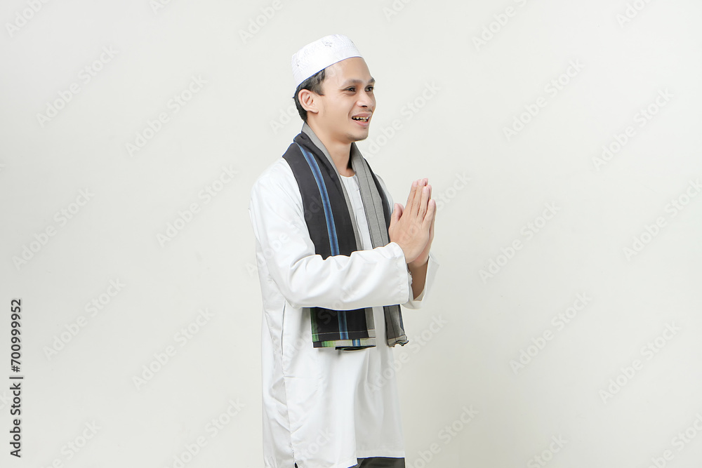happy asian muslim man greeting gesture. People religious Islam lifestyle concept. celebration Ramadan and ied Mubarak. on isolated background. happy asian muslim man greeting gesture. People religious Islam lifestyle concept. celebration Ramadan and ied Mubarak. on isolated background.